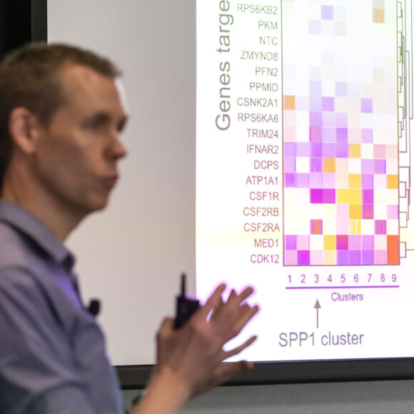 UCSF's Martin Kampmann presenting in front of a gene heat map