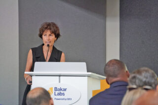 Dr. Julie Saba speaks at the podium in the Bakar Labs auditorium