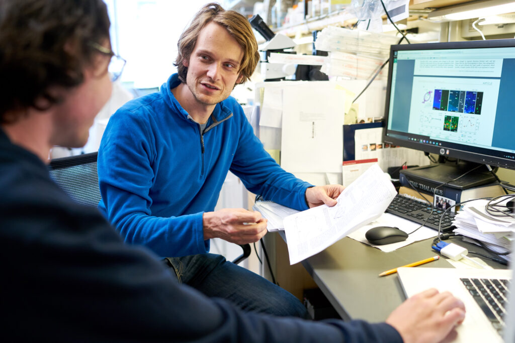 Associate Professors Tomasz Nowakowski, PhD, speaks with Alex Pollen, PhD, at the Eli and Edythe Broad Center of Regeneration Medicine and Stem Cell Research Center.