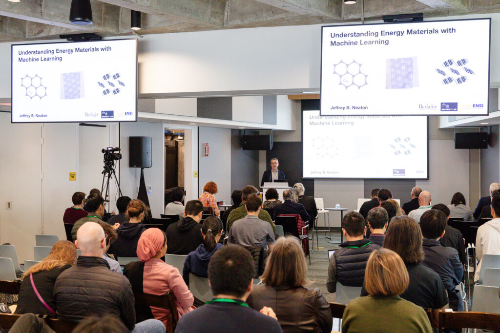 Jeffrey Neaton presents at the symposium to a full auditorium